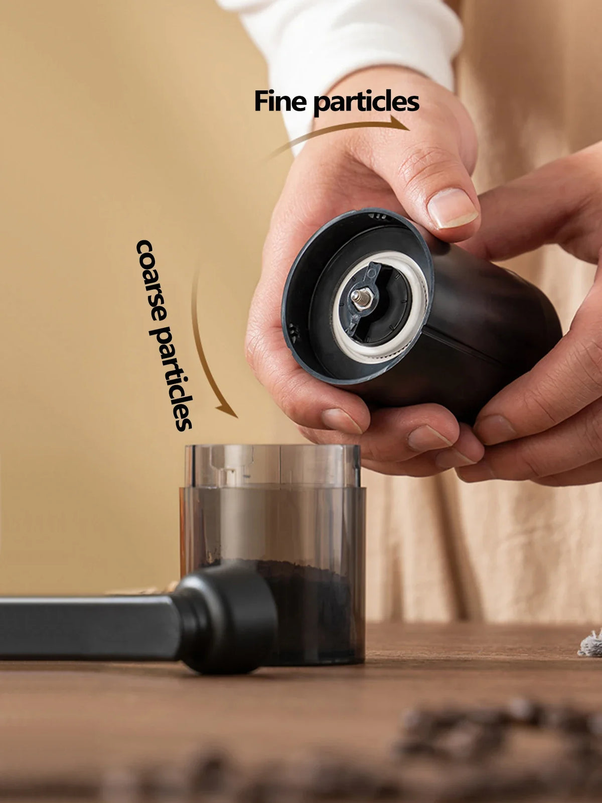 Hand adjusting the Trailgrind Manual Coffee Grinder's dial between fine and coarse grind settings